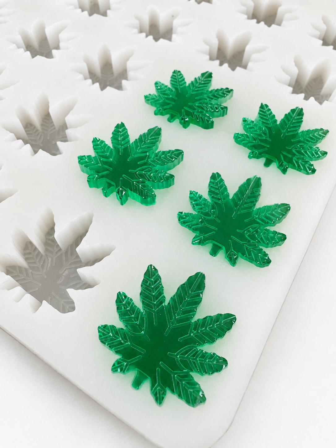 2.73mL cannabis leaf gummy mold with emerald green gummies