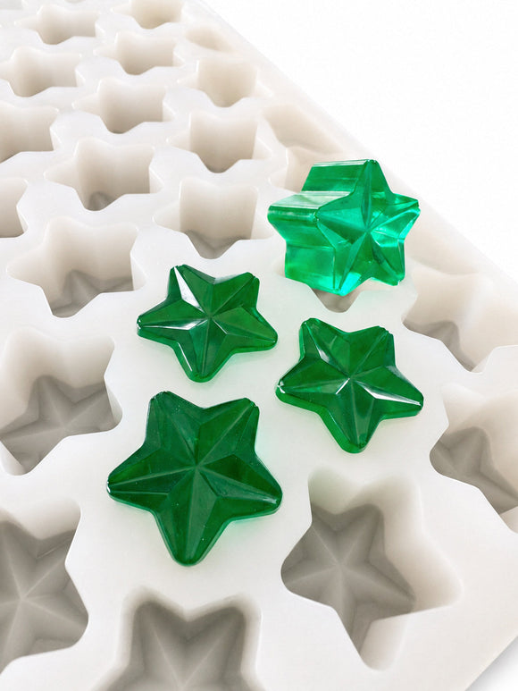 Close-up of a 4mL star gummy mold with 168 cavities and translucent emerald green gummies